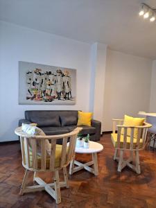 sala de estar con sofá, sillas y mesa en Apartamento centrico amueblado en Mendoza