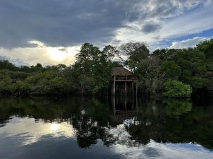 a building in the middle of a body of water at Juma Amazon Lodge in Autazes