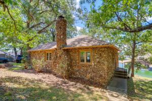 a small stone house with a chimney on top at Swim Dock and Views Lakefront Afton Vacation Rental in Afton