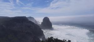 a view of the ocean with a mountain at Casa Mateus - Colares, Parque Natural Sintra Cascais in Sintra
