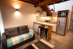 a living room with a couch and a kitchen at Studio Los Manzanos in San Carlos de Bariloche