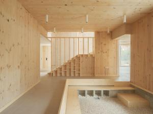 a room with wooden walls and stairs in a building at Hotel Amiuka in O Pedrouzo