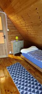 - une chambre avec un lit et un plafond en bois dans l'établissement Złote Piaski Mielenko, à Mielenko