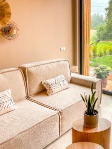 a living room with a couch and a table at Casa Bonita Niechorze in Niechorze