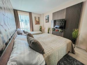 a bedroom with a bed and a large window at Villa Bauhaus Labi Garden wellness apartman in Siófok