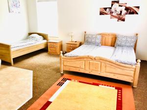 a bedroom with two beds and a rug at Ferienhof - Ferienwohnung in Gadebusch