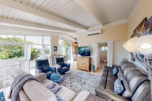 a living room with a couch and chairs and a tv at El Camino De La Luz Adventure in Santa Barbara