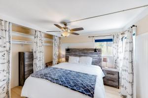 a bedroom with a bed and a ceiling fan at El Camino De La Luz Adventure in Santa Barbara