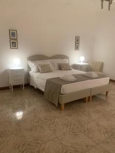a bedroom with a large bed and two night stands at Porta Napoli Rooms in Lecce