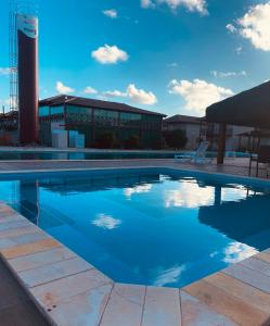 a large swimming pool in front of a building at Bangalô 39 in Tamandaré
