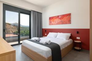 a bedroom with a bed with two towels on it at Villa Korali in Pastida +24 photos