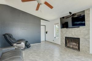 a living room with a fireplace and a ceiling fan at Shared living NOT A HOTEL in Phoenix