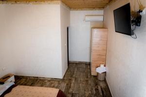 um quarto com uma cama e uma televisão na parede em Pescarul Deltei em Murighiol