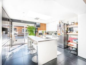 a kitchen with a white counter and a refrigerator at Casa Julie in De Panne