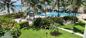 an aerial view of a resort with a pool and the ocean at NEW LUXURY APARTMENT 2Br 2Ba DIRECT BEACH ACCESS in Hollywood Beach