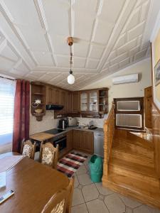 a kitchen with wooden cabinets and a table with chairs at Apartments Krnjic in Umag