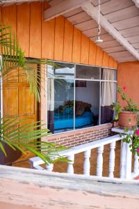 a balcony of a house with a window at Hotel & Restaurante Hanna Resort in Panajachel