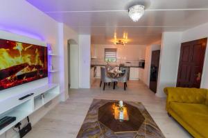 a living room with a couch and a tv at Havens corner in Sandton