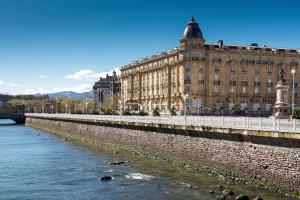 a large building next to a body of water at Hotel Maria Cristina, a Luxury Collection Hotel, San Sebastian in San Sebastián
