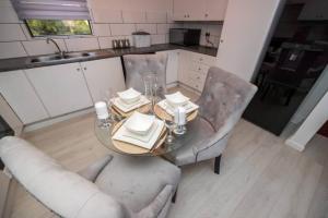 a kitchen with a table and two chairs and a table and chairsktop at Havens corner in Sandton +8 photos