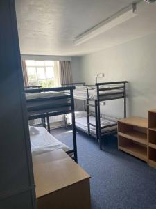 a dorm room with two bunk beds and a window at Marle Hall - Dorm Rooms (Blue) in Llandudno Junction