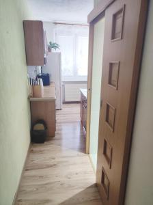 an open door to a kitchen with a hallway at Apartmán City in Zvolen