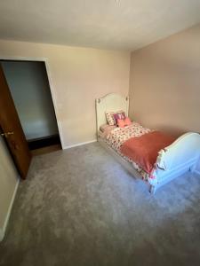 a small bedroom with a bed in a room at Hathaway a family home in Corvallis