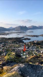 an aerial view of a town with a red object in the water at Et koselig hus i vakre Lofoten in Stamsund