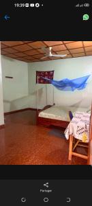 a room with a bed and a flag on the wall at Hôtel cœur des montagnes in Abomey