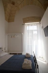 a bedroom with a bed with towels on it at Casa Sole in Lecce