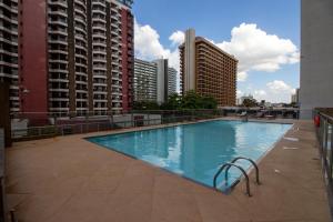 a large swimming pool on a building with tall buildings at Garvey Park Hotel in Brasilia