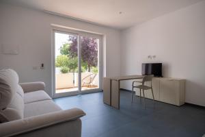 a living room with a couch and a table at Nautika Suites in Alghero