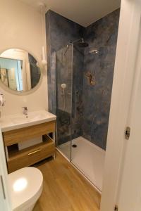 a bathroom with a shower and a toilet and a sink at Bel Mare Aqua Resort B&M in Międzyzdroje +14 photos