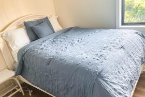a bedroom with a bed with a blue comforter at Southwinds C8 in Atlantic Beach