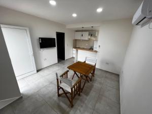 a kitchen and dining room with a table and chairs at DEPARTAMENTOS DEL GOLF in Macachín
