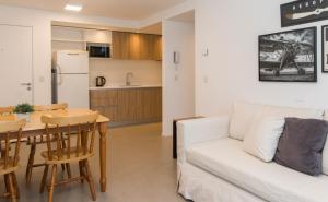 a living room with a white couch and a table at Austral Departamentos in Ushuaia