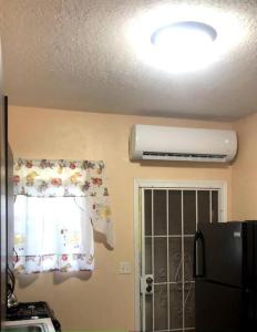 a kitchen with a refrigerator and a window at Paradise Haven in Nassau