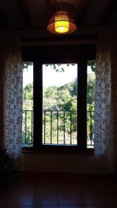a window in a room with a view of a balcony at Casa Rural Espeñitas in La Alberca +12 photos