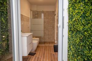 a small bathroom with a toilet and a shower at Asmara exclusive "Loft industrial" in Brindisi +51 photos
