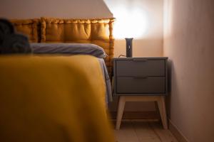 a bedroom with a bed and a nightstand with a television at Asmara exclusive "Loft industrial" in Brindisi
