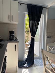 una cocina con cortina delante de una puerta en Garsoniera la casa en Timisoara