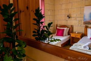 A bed or beds in a room at Orchidea Xaghra