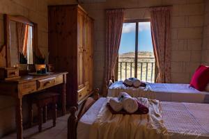 A bed or beds in a room at Orchidea Xaghra