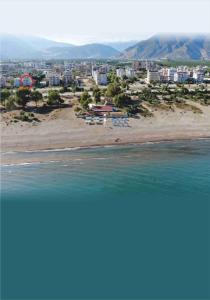 a view of a beach with buildings and the ocean at Finike Apart in Finike