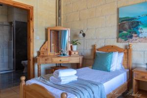 A bed or beds in a room at Orchidea Xaghra