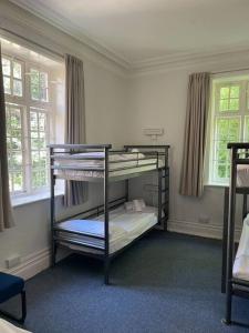 a bedroom with two bunk beds in a room at Marle Hall - Dorm Rooms (Green) in Llandudno Junction