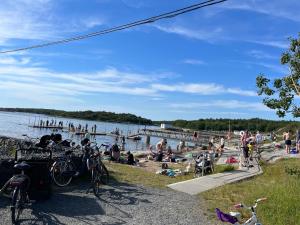 a group of people on the beach at a lake at Luxury Modern Home near Gothenburg & 3 min t Beach in Billdal
