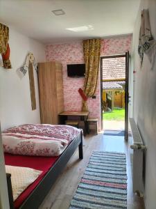 a bedroom with a bed and a sliding glass door at Vila Noris in Borşa