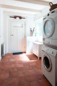 a laundry room with a washer and dryer at Bed and breakfast Jan in Edam