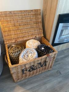 a wicker basket with different types of donuts in it at Gannets Rest - Spacious Static Caravan with Sea Views in Polperro
